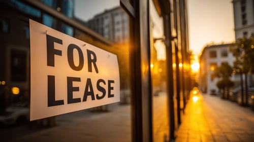 office building with "for lease" sign in window