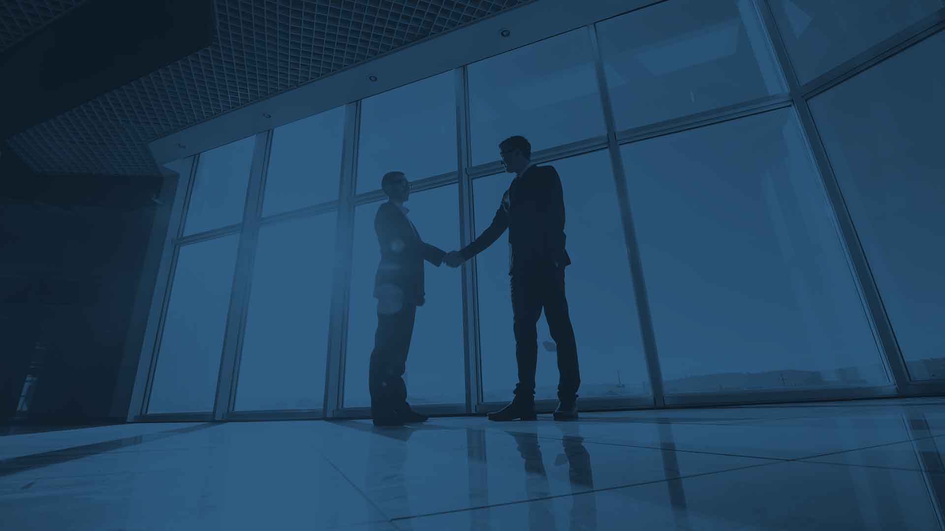 Two people shaking hands in a building