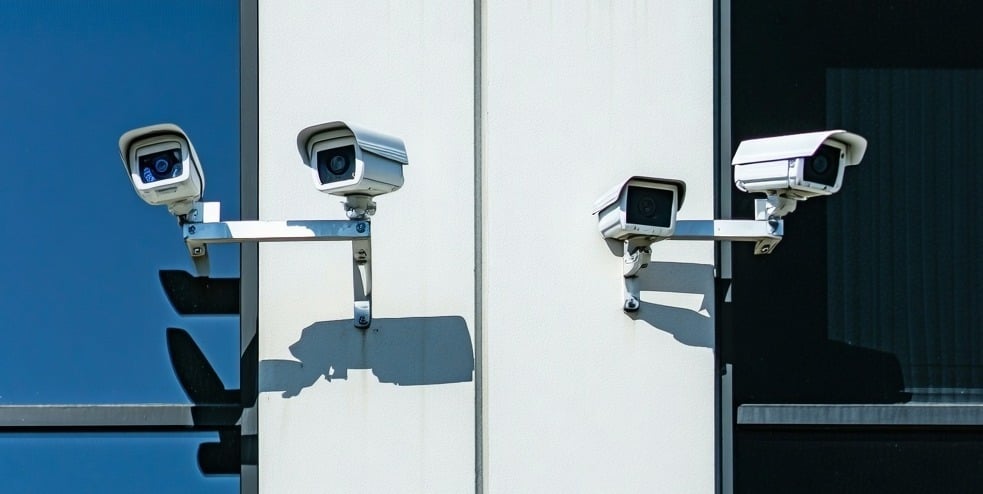 https://www.security101.com/hubfs/AI-Generated%20Media/Images/The%20image%20depicts%20a%20modern%20office%20building%20in%20San%20Mateo%20California%20with%20security%20cameras-1-1.jpeg