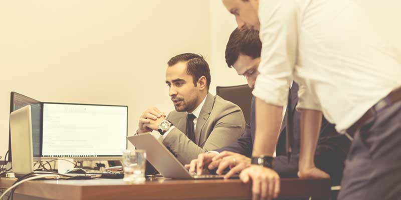 A-business-owner-searches-online-for-a-commercial-security-provider.